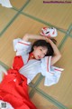 A woman in a red and white dress laying on the floor.