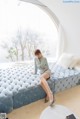 A woman sitting on top of a blue couch.