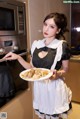 A woman holding a plate of food in front of a microwave.